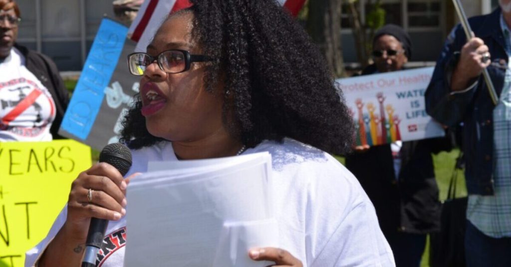 Dozens march to Flint city hall as the water crisis turns 10 years old