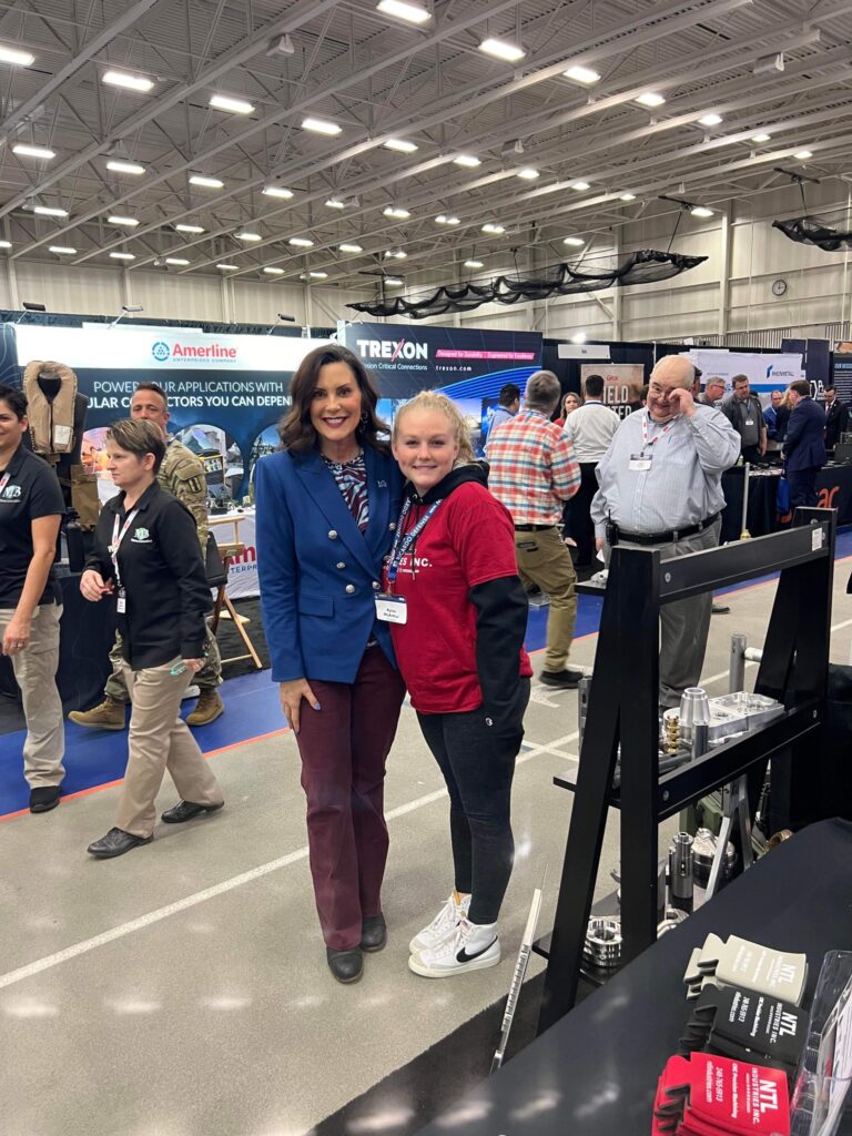 Governor Whitmer posing for a photo at an expo.