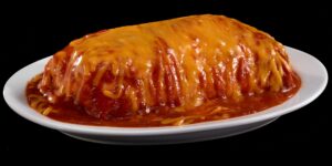 A giant burrito smothered in red sauce and yellow cheese.