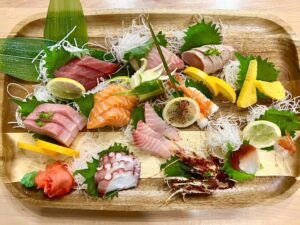 A beautiful display of sashimi on a wooden board.
