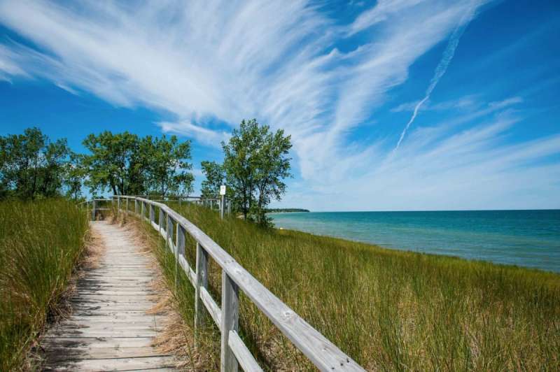 Port Austin, Michigan, United States - July 7th 2016: A view of the beach and the lake where Saginaw Bay and Lake Huron meet at Port Crescent State Park.