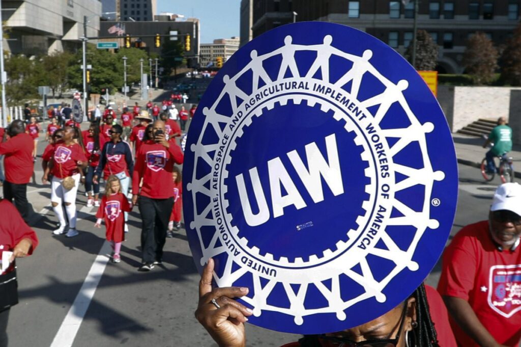 United Auto Workers members walk in the Labor Day parade in Detroit, Sept. 2, 2019.