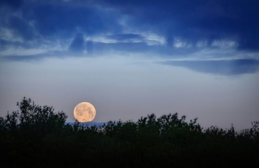 Full moon in a blue sky.