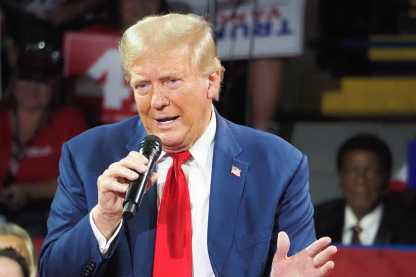 Trump mocks conspiracy theorist label, plays to international auto fears at Flint town hall 