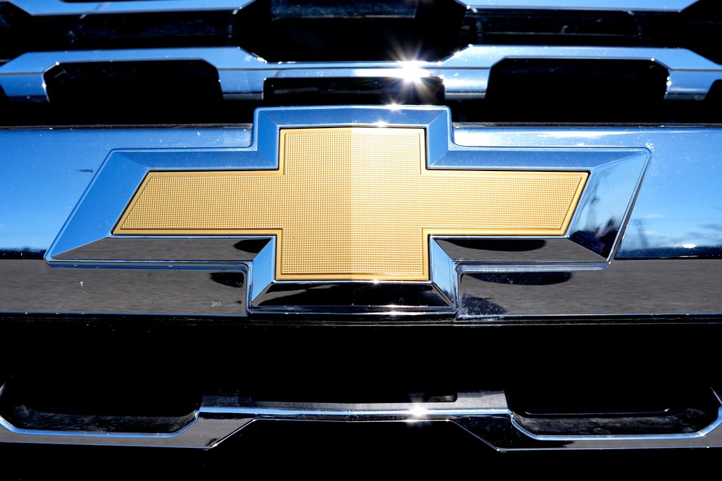 General Motors lays off about 1,000 workers, cutting costs to compete in a crowded automobile market