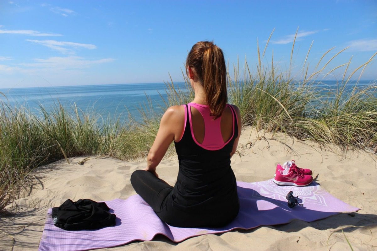 yogi facing the beach