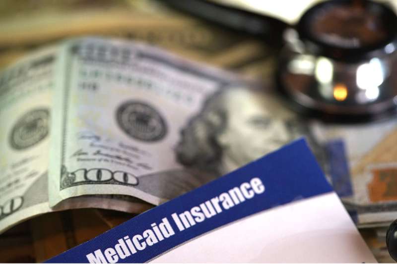 medicaid card in front of money