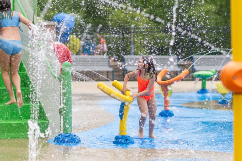 children run and play in the water of a michigan splash pad