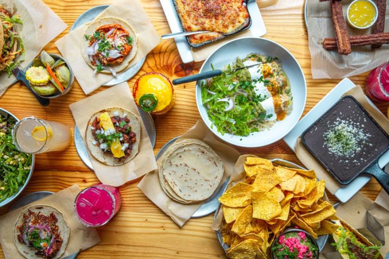 A table filled with Mexican food specialties at Donkey Taqueria, one of the best Mexican restaurants in Grand Rapids