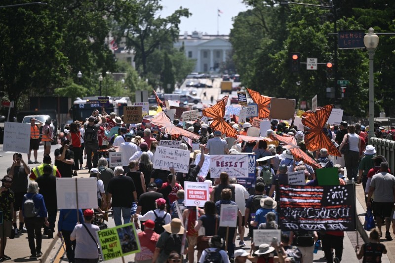 Protesters march towards the White House during a May Day Strong Coalition rally in Washington, DC on May 1, 2025. (Photo by Brendan SMIALOWSKI / AFP)