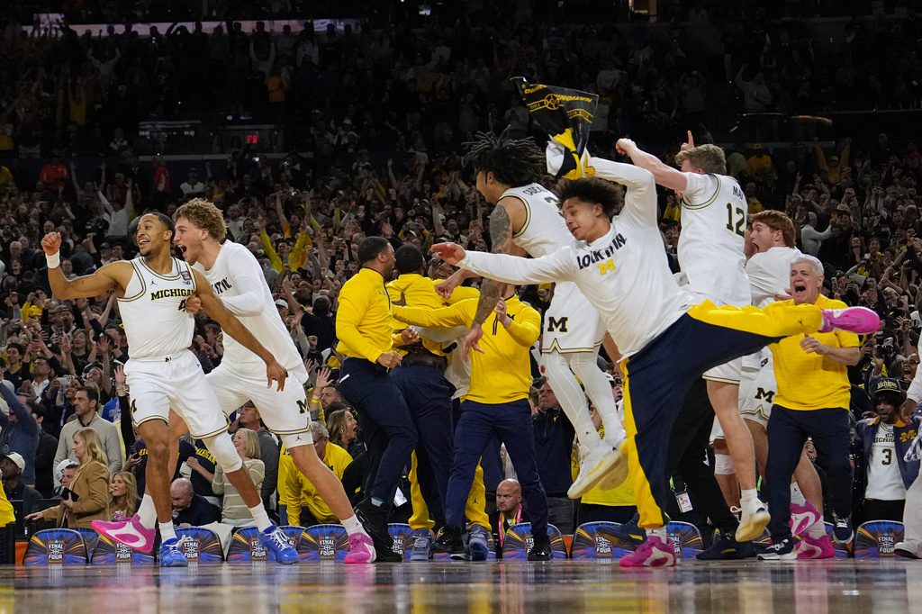 Michigan muscles its way to program's 2nd national title, beating stubborn UConn 69-63