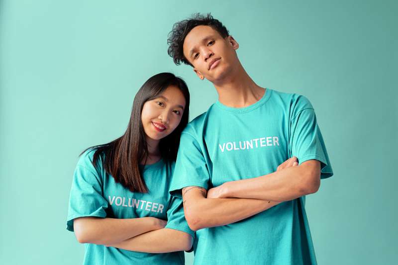 protests. A Man and Woman in "volunteer" Blue Shirt Standing