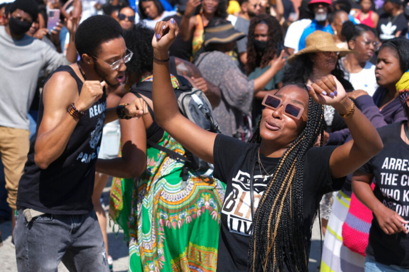 People dance as they celebrate during a Juneteenth commemoration at Leimert Park Plaza on Saturday, June 19, 2021, in Los Angeles. (AP Photo/Ringo H.W. Chiu)