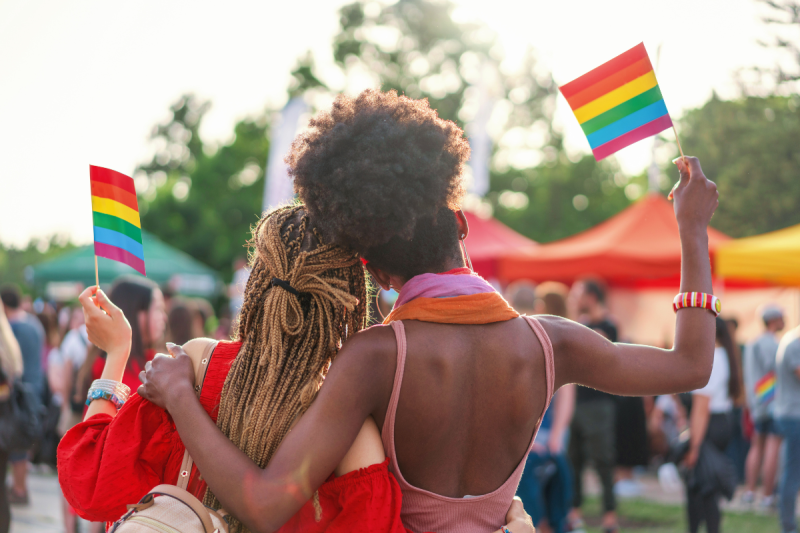 Pride in Michigan. Couple standing with pride flags.